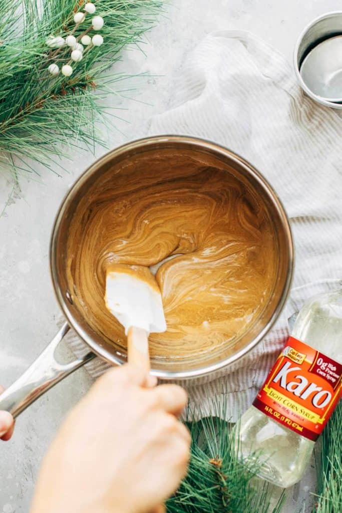 mixing peanut butter into a hot syrup and sugar mixture