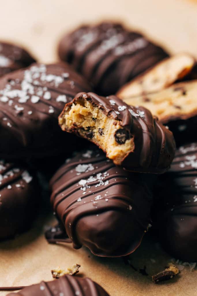 close up on a bite taken from a chocolate covered cookie dough egg