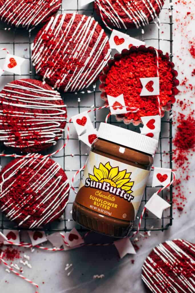 red velvet cookies with a jar of sunbutter
